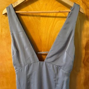 Lavender gray silk gown with deep v front and high slit.